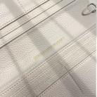 Close-up of a textured beige handbag with 'Minimalistic Budget' branding.