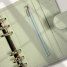 Light green planner with a zipper pocket on a white background